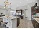 Modern kitchen with an island, dark cabinets, pendant lighting, and stainless steel appliances at 3870 Valles Caldera Ct, Las Vegas, NV 89118