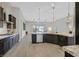 Modern kitchen features granite countertops, stainless steel appliances, and a spacious island with pendant lighting at 3870 Valles Caldera Ct, Las Vegas, NV 89118