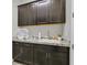 Functional laundry room with granite countertops, cabinet storage, and stylish fixtures at 3870 Valles Caldera Ct, Las Vegas, NV 89118