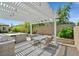 Cozy outdoor dining area under a pergola with ambient lighting and desert landscaping at 3870 Valles Caldera Ct, Las Vegas, NV 89118