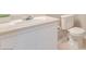Bathroom features a white sink, white toilet, and cream walls at 3953 Rebecca Raiter Ave # 101, Las Vegas, NV 89110