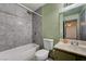Modern bathroom features tile, a tub and shower, a toilet, and a sink with vanity at 441 N Lamb Blvd # E, Las Vegas, NV 89110