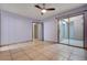 Spacious bedroom with tile flooring, ceiling fan, access to an outdoor patio, and ensuite bathroom at 441 N Lamb Blvd # E, Las Vegas, NV 89110