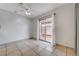 Bedroom with tile flooring, neutral walls, ceiling fan, and access to patio at 441 N Lamb Blvd # E, Las Vegas, NV 89110