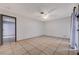 Bright bedroom with tile flooring, ceiling fan, and ensuite bathroom, providing a comfortable retreat at 441 N Lamb Blvd # E, Las Vegas, NV 89110