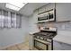 Updated kitchen features stainless steel oven, microwave, and tiled backsplash at 441 N Lamb Blvd # E, Las Vegas, NV 89110