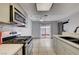Modern kitchen with stainless steel appliances, gas range, mosaic backsplash, and sliding door to patio at 441 N Lamb Blvd # E, Las Vegas, NV 89110