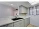 Kitchen sink with quartz countertop, modern faucet, and ample cabinet storage at 441 N Lamb Blvd # E, Las Vegas, NV 89110