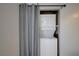 Laundry area with stacked washer and dryer concealed by a curtain at 441 N Lamb Blvd # E, Las Vegas, NV 89110