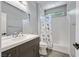 Bathroom featuring a vanity with a sink, a large mirror, and a shower/tub combo at 4432 Vicobello Ave, Las Vegas, NV 89141