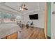 Primary bedroom featuring a tray ceiling, wood floors and workout equipment at 4432 Vicobello Ave, Las Vegas, NV 89141