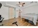 Secondary bedroom featuring wood floors, tray ceiling and sliding door at 4432 Vicobello Ave, Las Vegas, NV 89141