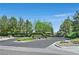 Community entrance with lush landscaping and mature trees at 4432 Vicobello Ave, Las Vegas, NV 89141