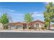 Charming single-story home with a three-car garage, lush landscaping, and a welcoming entrance at 4432 Vicobello Ave, Las Vegas, NV 89141