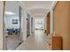 Inviting hallway featuring tiled flooring, decorative columns, and a view into the living spaces at 4432 Vicobello Ave, Las Vegas, NV 89141