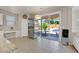 Spacious kitchen area with stainless steel refrigerator and sliding glass doors to a backyard oasis at 4432 Vicobello Ave, Las Vegas, NV 89141