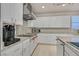Updated kitchen featuring granite countertops, stainless steel appliances, and ample cabinet space at 4432 Vicobello Ave, Las Vegas, NV 89141