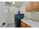 This laundry room features modern appliances, a utility sink, and built-in cabinets at 4432 Vicobello Ave, Las Vegas, NV 89141