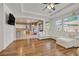 Bright and open living room with hardwood floors seamlessly connecting to the modern kitchen at 4432 Vicobello Ave, Las Vegas, NV 89141