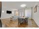 Bright living room with hardwood floors, a comfortable sofa, and a dining area with modern decor at 4432 Vicobello Ave, Las Vegas, NV 89141