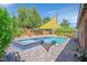 Backyard features a pool, integrated jacuzzi, and a covered lounge area at 4432 Vicobello Ave, Las Vegas, NV 89141