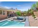 Backyard pool with built-in hot tub, lounge chairs, and a shade structure creates a relaxing retreat at 4432 Vicobello Ave, Las Vegas, NV 89141
