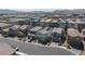 Expansive aerial view of modern homes in a well-planned community near mountains and featuring neutral color schemes at 4707 Pink Jasper Ct, Las Vegas, NV 89141