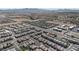Wide aerial shot showcasing an extensive neighborhood in a desert landscape with uniform houses and orderly street layouts at 4707 Pink Jasper Ct, Las Vegas, NV 89141
