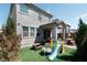 Charming backyard with manicured lawn, play area, and outdoor seating, ideal for Gathering gatherings and relaxation at 4707 Pink Jasper Ct, Las Vegas, NV 89141