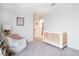 Bedroom with crib, chair, and access to a bathroom, provides a peaceful retreat for baby and parents alike at 4707 Pink Jasper Ct, Las Vegas, NV 89141