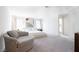 Spacious bedroom featuring neutral tones, a comfortable chair, and an inviting atmosphere at 4707 Pink Jasper Ct, Las Vegas, NV 89141