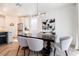 Bright dining area features a large wood table, seating for six, and herringbone flooring at 4707 Pink Jasper Ct, Las Vegas, NV 89141