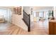 Inviting entryway with beautiful wood-look floors, open staircase and views of the living room space at 4707 Pink Jasper Ct, Las Vegas, NV 89141