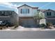 Charming two-story home features a neutral color scheme, brick accents and a paved driveway at 4707 Pink Jasper Ct, Las Vegas, NV 89141