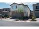 Two-story home shows great curb appeal with a neutral color palette, brick accents, and an attached garage at 4707 Pink Jasper Ct, Las Vegas, NV 89141