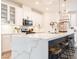 Modern kitchen with large island, stainless steel appliances, white cabinetry, and quartz countertops at 4707 Pink Jasper Ct, Las Vegas, NV 89141