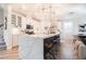 Open kitchen features a large island with quartz countertop, bar stool seating, and herringbone flooring at 4707 Pink Jasper Ct, Las Vegas, NV 89141