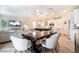Open-concept living space with dining table, chairs, and a modern kitchen in the background at 4707 Pink Jasper Ct, Las Vegas, NV 89141