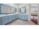 Bright bathroom featuring dual vanities, tile counters, and mosaic-framed mirrors, with a view to bonus room at 5148 Forest Oaks Dr, Las Vegas, NV 89149
