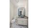 Stylish powder room with a vessel sink, granite countertop, and mosaic tile mirror at 5148 Forest Oaks Dr, Las Vegas, NV 89149