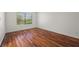 Bright bedroom featuring wood-look floors, a large window, and neutral walls at 5148 Forest Oaks Dr, Las Vegas, NV 89149