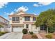 Charming two-story home features a well-manicured front yard, two-car garage and a classic design at 5148 Forest Oaks Dr, Las Vegas, NV 89149