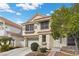 Charming two-story home with a well-maintained front yard, complemented by desert landscaping and a two car garage at 5148 Forest Oaks Dr, Las Vegas, NV 89149