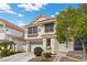 Charming two-story home with a tile roof, well-manicured landscaping, and an attached two-car garage at 5148 Forest Oaks Dr, Las Vegas, NV 89149