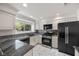 Modern kitchen featuring granite countertops, stainless steel appliances, and bright white cabinetry at 5148 Forest Oaks Dr, Las Vegas, NV 89149