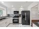 Modern kitchen featuring granite countertops, stainless steel appliances, and bright white cabinetry at 5148 Forest Oaks Dr, Las Vegas, NV 89149
