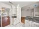 Bright kitchen featuring granite countertops, white cabinets, and marble floors leading into the adjoining living room at 5148 Forest Oaks Dr, Las Vegas, NV 89149