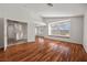 Spacious living room with wood floors, high ceilings, window seat, and bright natural light at 5148 Forest Oaks Dr, Las Vegas, NV 89149