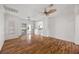 Bright, open living room featuring wood floors, ceiling fan, and sliding doors to outdoor space at 5148 Forest Oaks Dr, Las Vegas, NV 89149