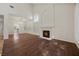 Bright living room with wood floors, a fireplace, large windows, and an elegant chandelier at 5148 Forest Oaks Dr, Las Vegas, NV 89149